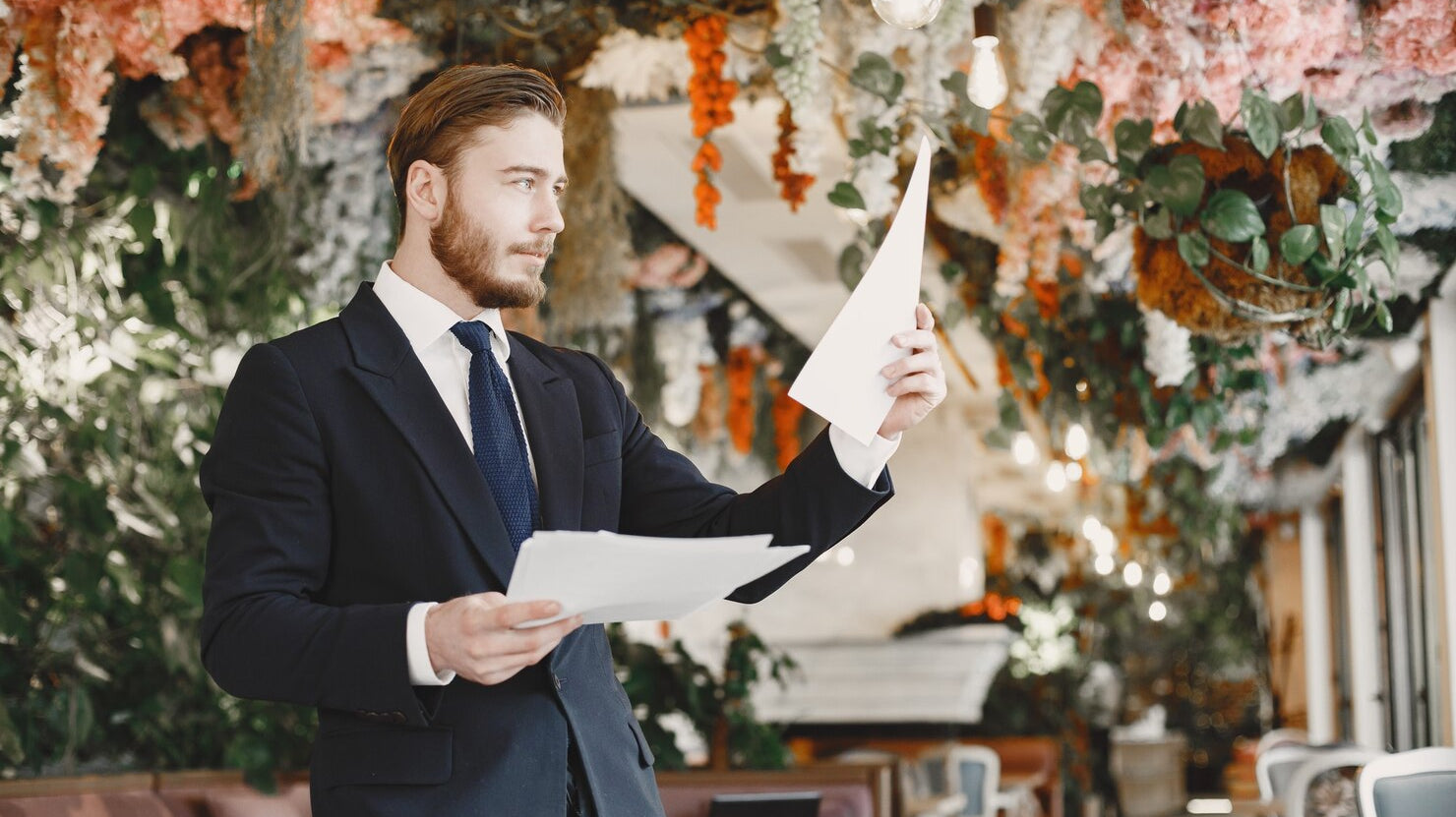 Confident groom in black suit preparing for wedding day