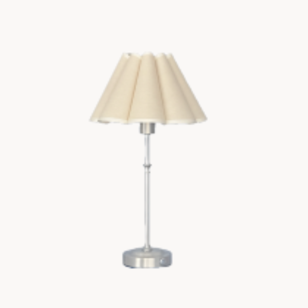 Cream pleated table lamp with silver base.