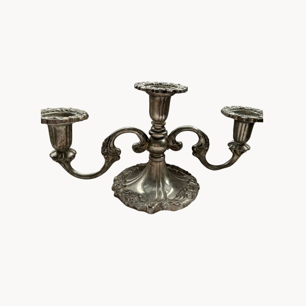 A vintage silver three-armed candelabra.