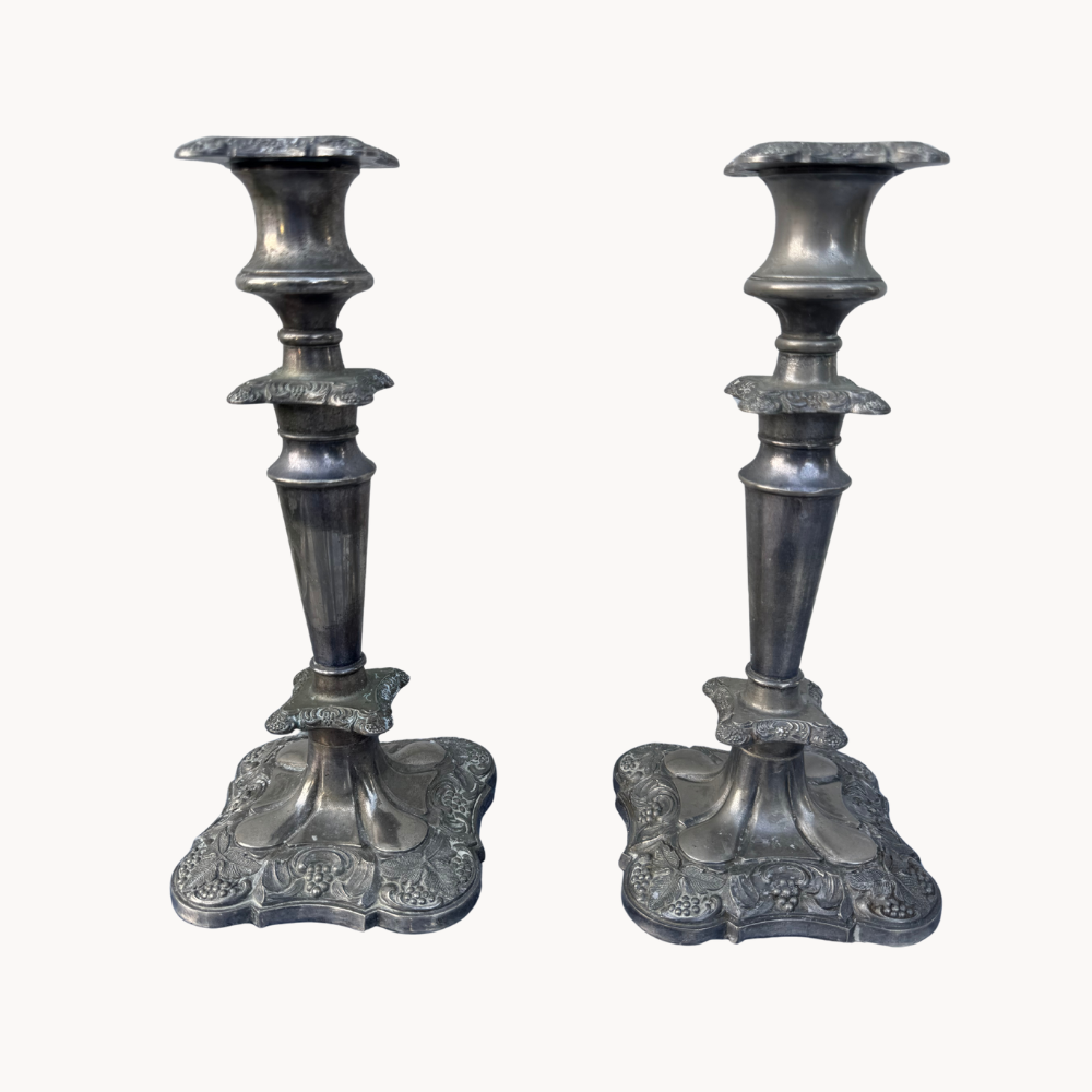 Pair of ornate silver candlesticks.