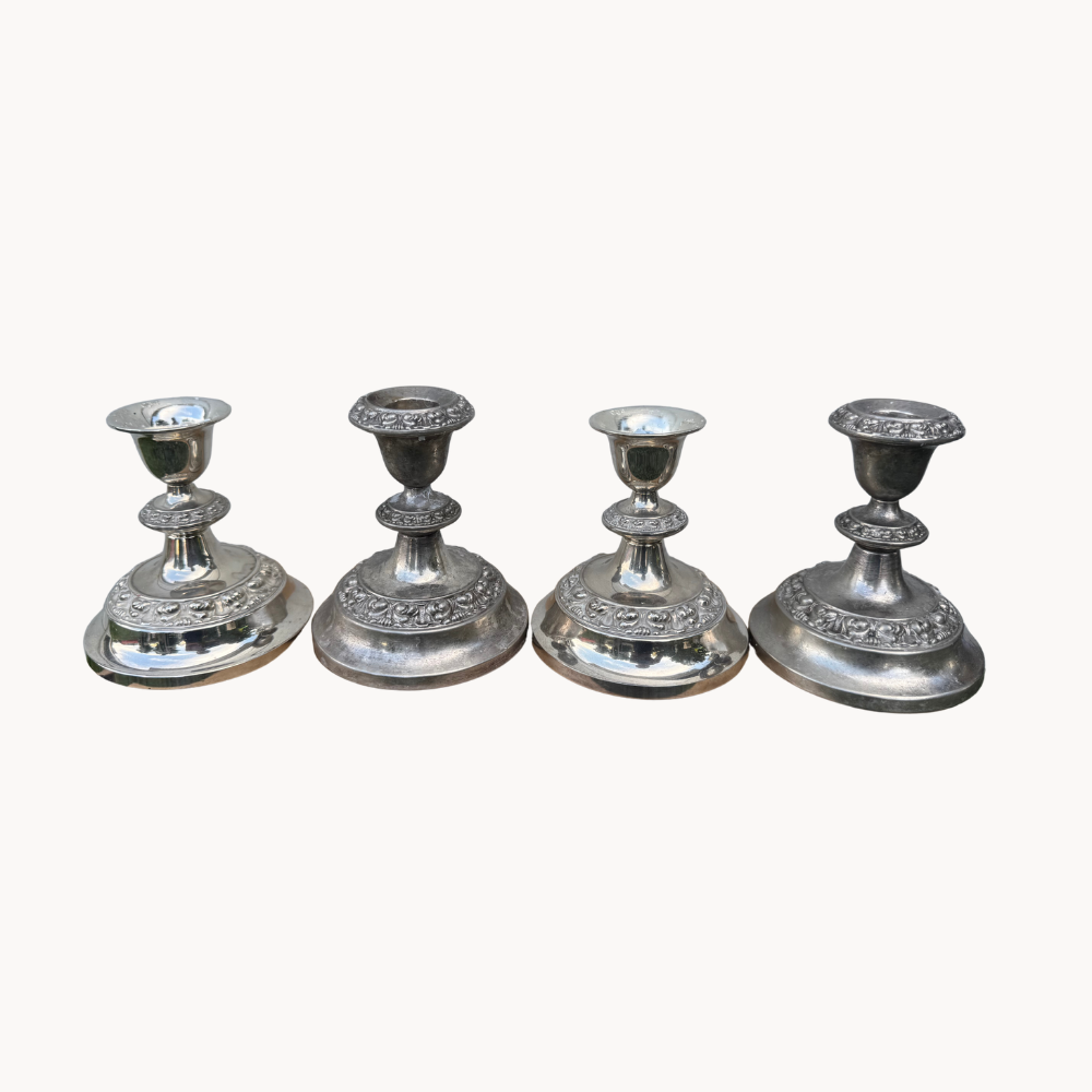 Four vintage silver-plated Ianthe candlesticks.