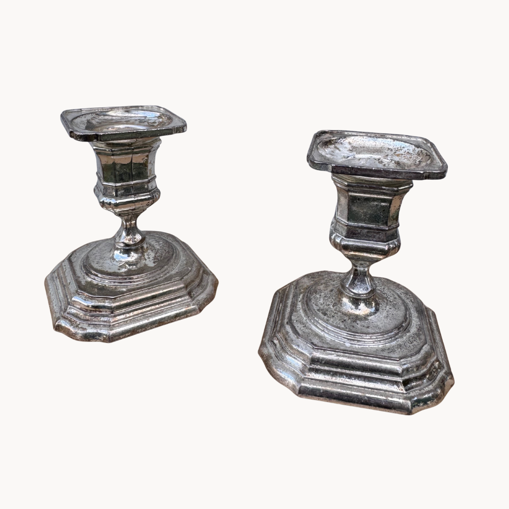 A pair of antique silver candlesticks.