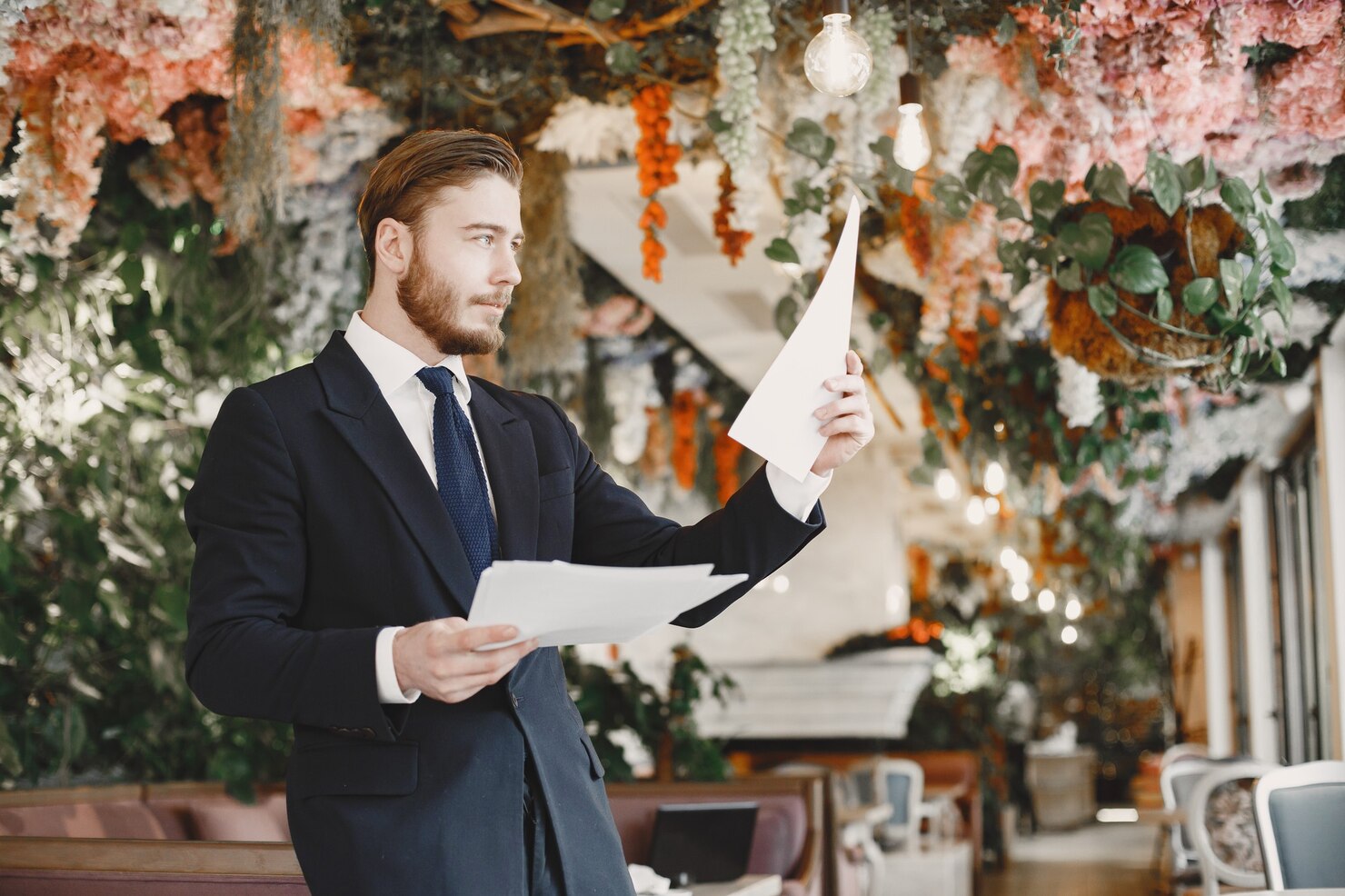Confident groom in black suit preparing for wedding day