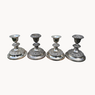 Four vintage silver-plated Ianthe candlesticks. 